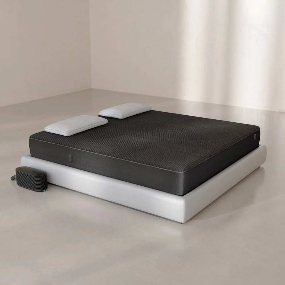 Eight Sleep Pod 6 Cover fitted to a mattress, with the Hub beside the bed